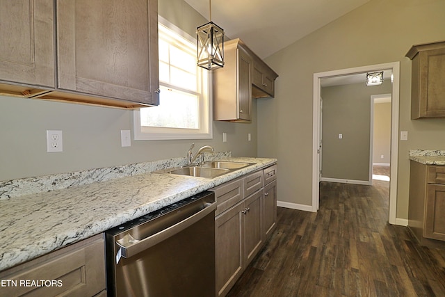 kitchen with dark wood-type flooring, sink, dishwasher, vaulted ceiling, and pendant lighting