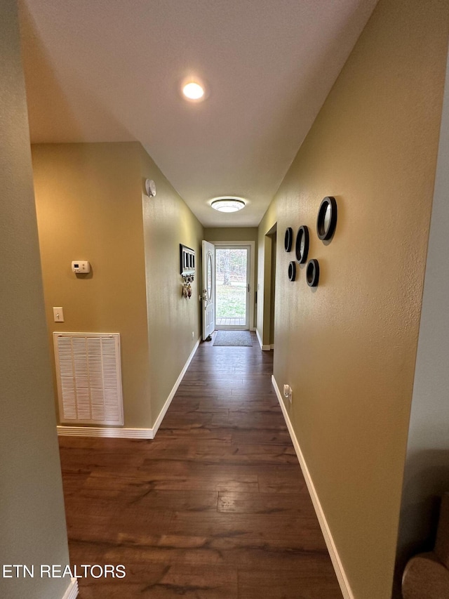 hallway with dark wood-type flooring