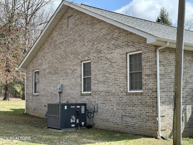 view of property exterior featuring a yard and central AC unit