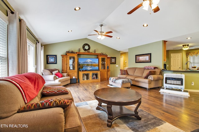 living room featuring ceiling fan, vaulted ceiling, and wood-type flooring