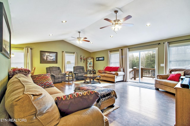 living room featuring ceiling fan, dark hardwood / wood-style floors, and vaulted ceiling