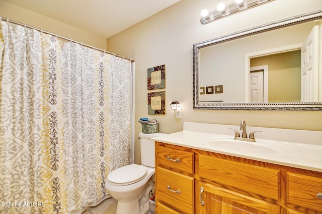 bathroom featuring toilet and vanity