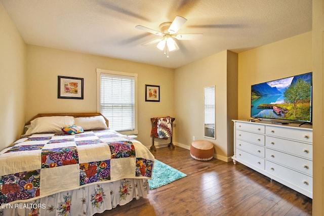 bedroom featuring dark hardwood / wood-style flooring and ceiling fan