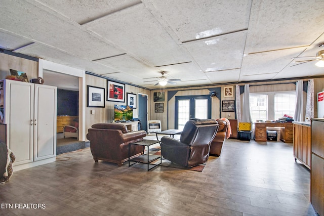 living room with ceiling fan, dark hardwood / wood-style floors, and french doors