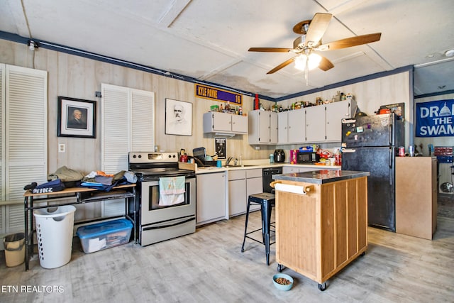 kitchen with light hardwood / wood-style floors, black refrigerator, stainless steel electric stove, a center island, and ceiling fan