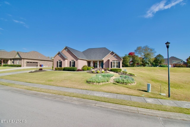 view of front facade with a front lawn and a garage