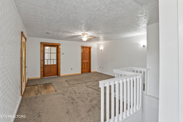 entrance foyer with light carpet and a textured ceiling