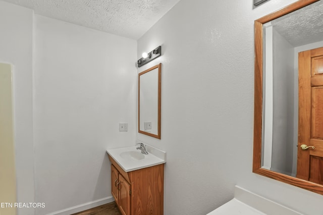 bathroom with vanity and a textured ceiling