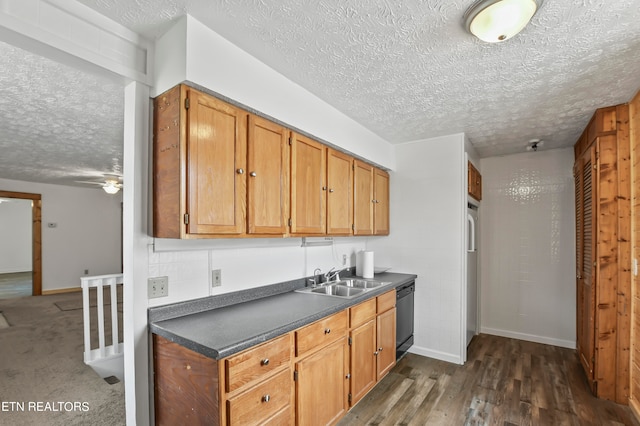 kitchen with ceiling fan, sink, black dishwasher, dark carpet, and a textured ceiling