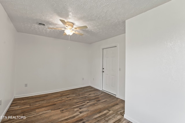 unfurnished room with dark hardwood / wood-style flooring, a textured ceiling, and ceiling fan