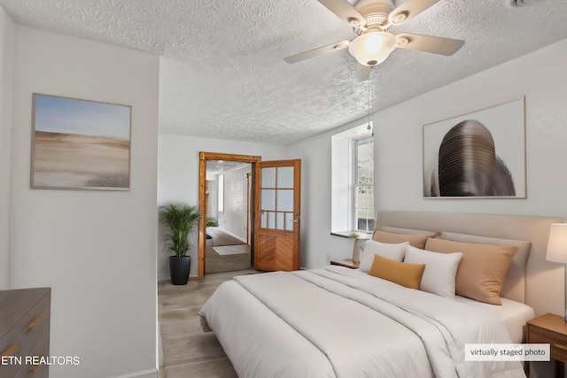 bedroom with a textured ceiling and ceiling fan