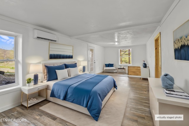 bedroom featuring an AC wall unit and hardwood / wood-style floors