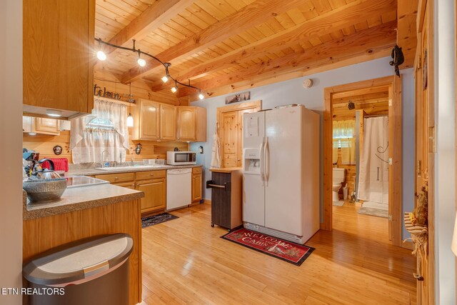 kitchen with hanging light fixtures, beamed ceiling, white appliances, light hardwood / wood-style floors, and wooden ceiling