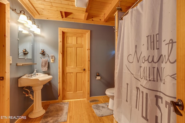 bathroom with toilet, wood ceiling, and wood-type flooring