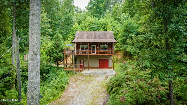 cabin featuring a deck and a garage