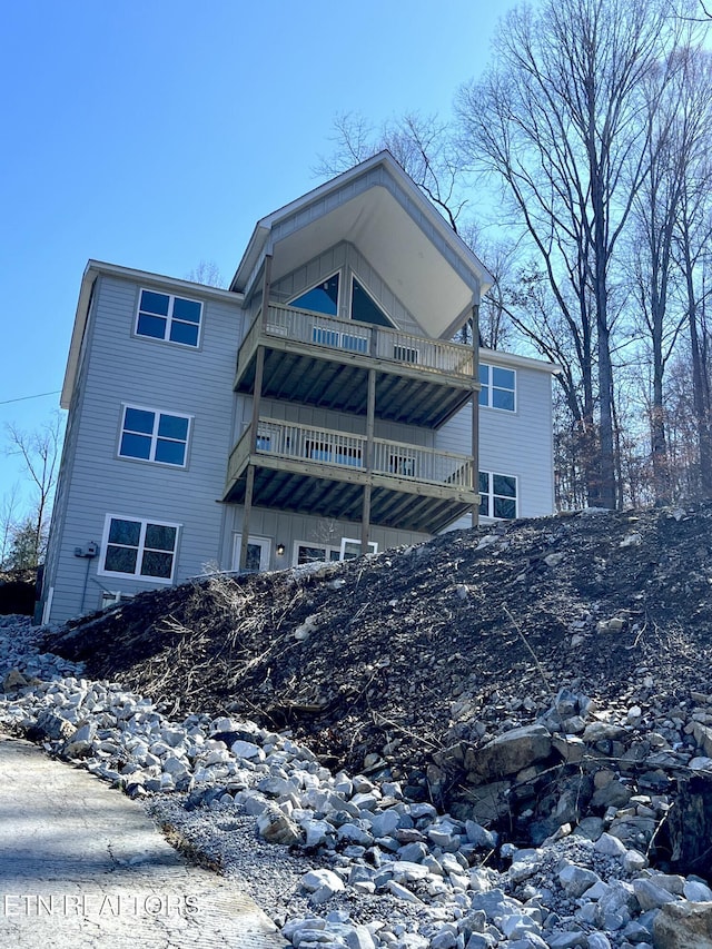 back of property with a balcony