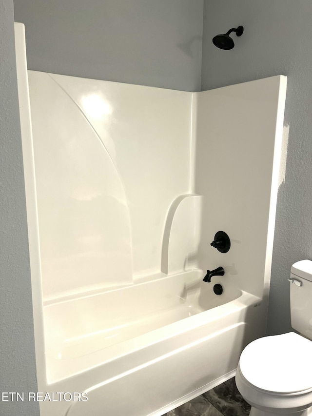 bathroom featuring toilet and shower / bathtub combination