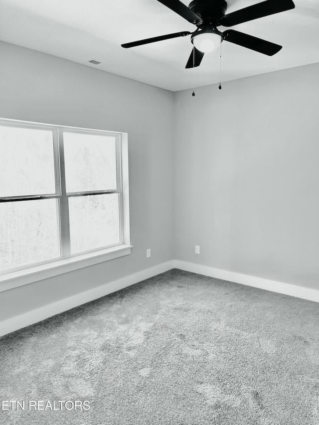 empty room featuring visible vents, baseboards, ceiling fan, and carpet flooring