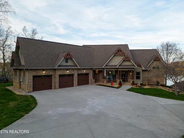 craftsman-style home with a front yard and a garage