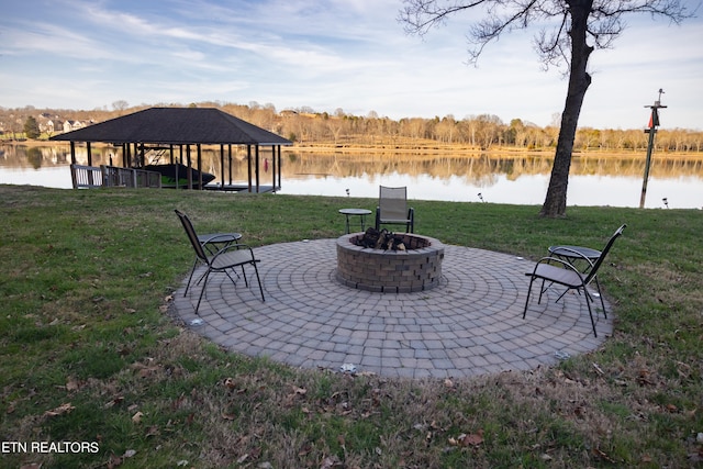 view of patio / terrace with a water view, a gazebo, and an outdoor fire pit