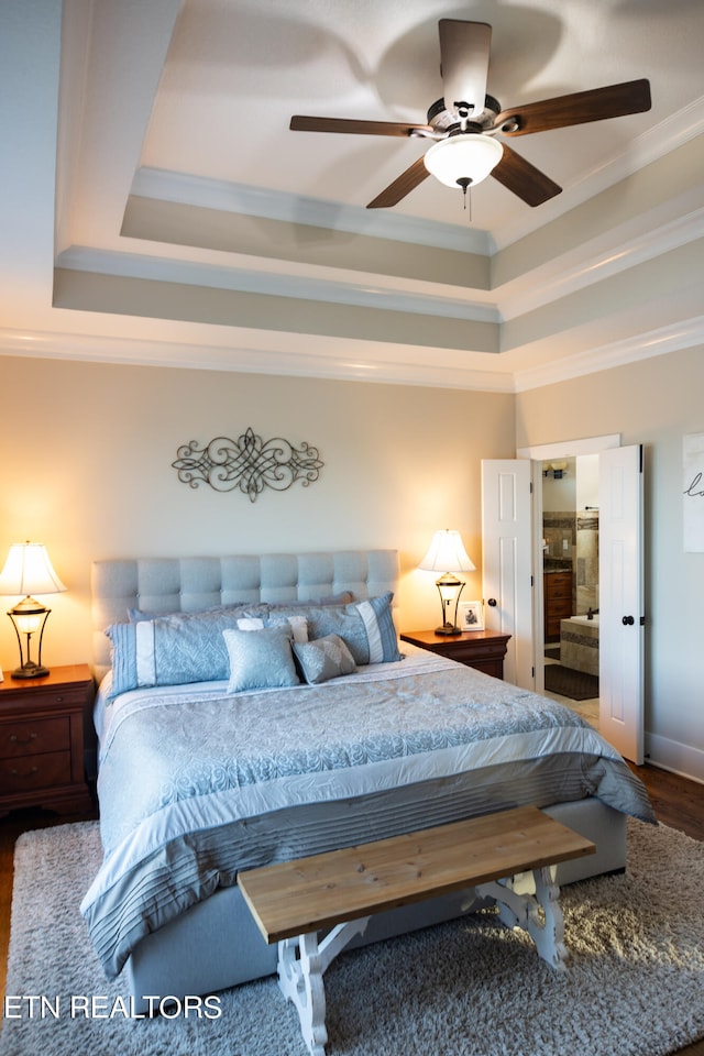 bedroom with a raised ceiling, ornamental molding, ceiling fan, and dark wood-type flooring