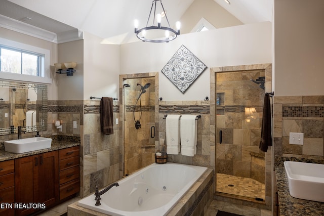 bathroom with an inviting chandelier, separate shower and tub, tile flooring, and vanity