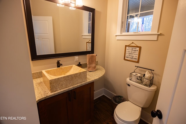 bathroom featuring oversized vanity, toilet, and hardwood / wood-style floors