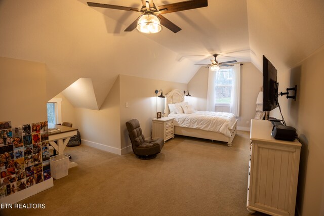 carpeted bedroom with ceiling fan and vaulted ceiling