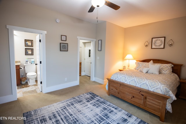 carpeted bedroom featuring ensuite bathroom and ceiling fan