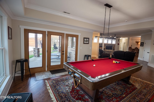 rec room featuring pool table, a raised ceiling, dark hardwood / wood-style flooring, and ornamental molding