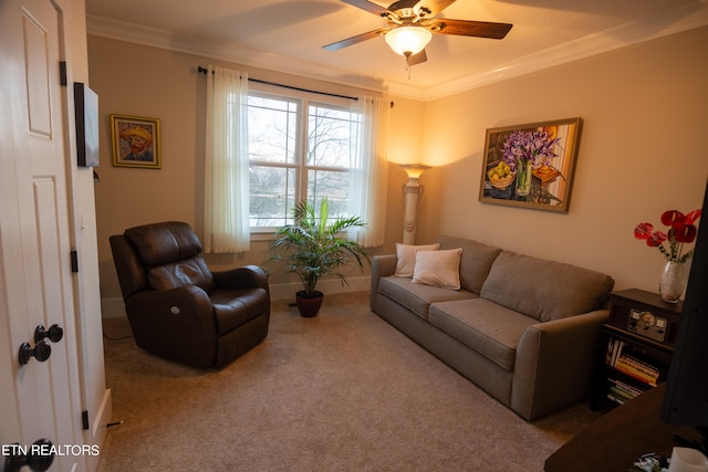 carpeted living room featuring ornamental molding and ceiling fan