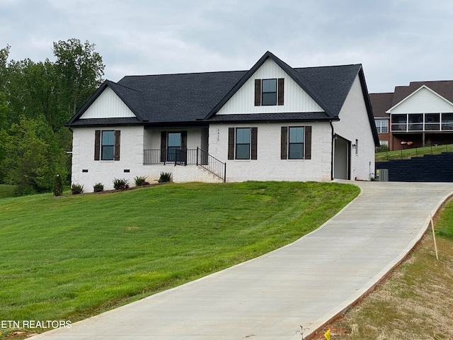 view of front of property with a garage and a front lawn