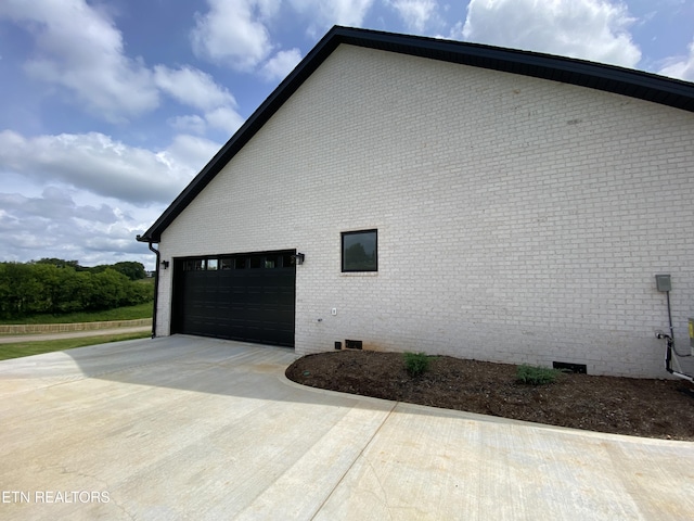 view of side of home with a garage