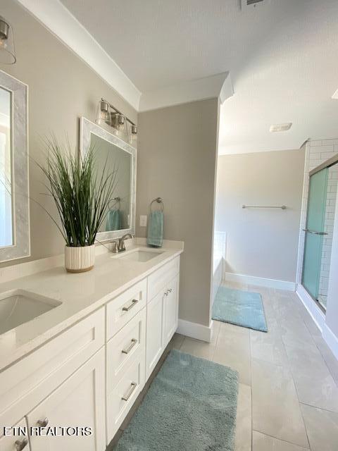 bathroom with tile patterned floors, vanity, crown molding, and independent shower and bath