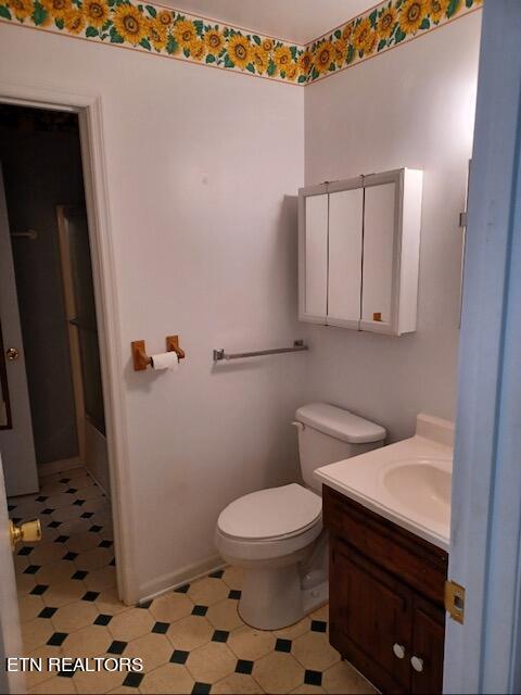 bathroom with vanity, tile flooring, and toilet