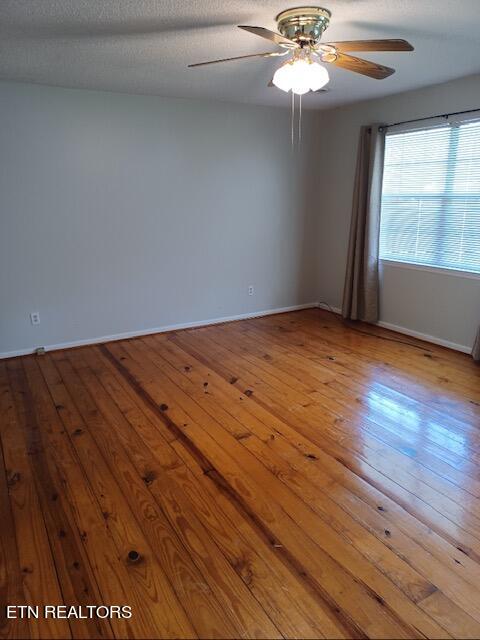 unfurnished room featuring ceiling fan, a textured ceiling, and light hardwood / wood-style floors