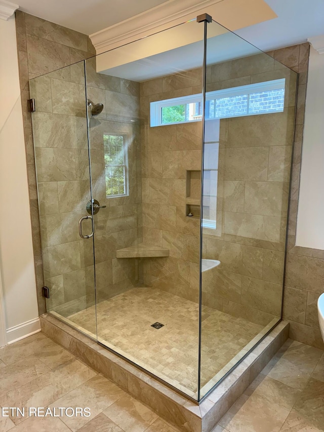 bathroom with ornamental molding and a shower with door