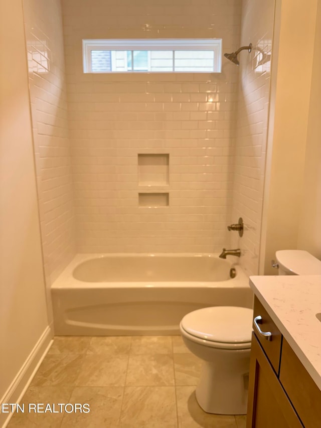 full bathroom featuring tiled shower / bath, vanity, tile patterned floors, and toilet