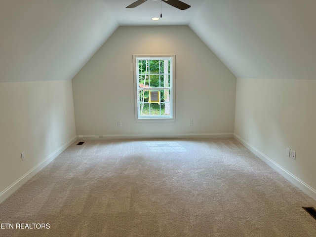 bonus room featuring vaulted ceiling, light colored carpet, and ceiling fan