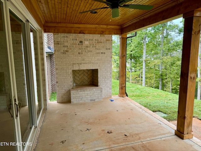 view of patio with an outdoor brick fireplace and ceiling fan