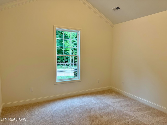 empty room with ornamental molding, lofted ceiling, and light carpet