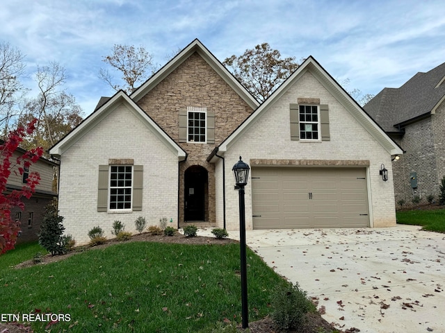 view of front of home with a garage and a front lawn