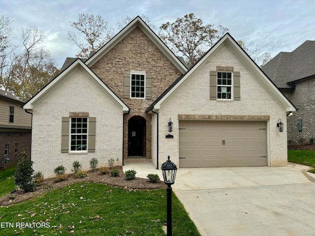 view of front of home featuring a garage and a front lawn