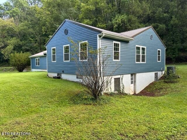 view of home's exterior with a yard