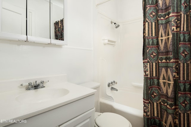 full bathroom with shower / bath combo with shower curtain, toilet, and vanity with extensive cabinet space