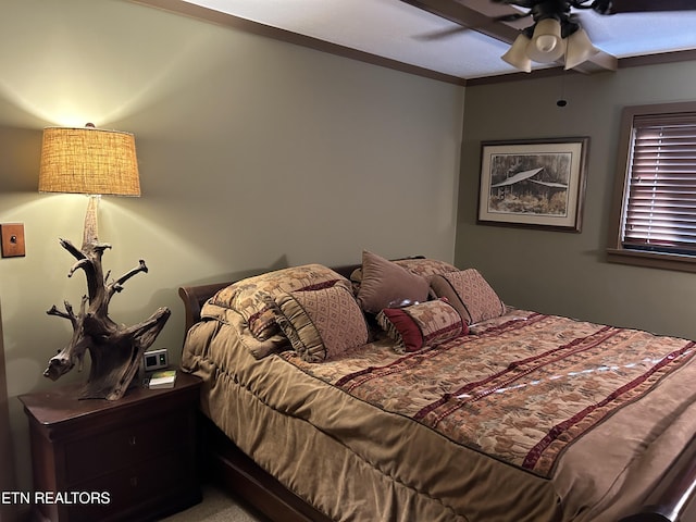 bedroom with ornamental molding and ceiling fan