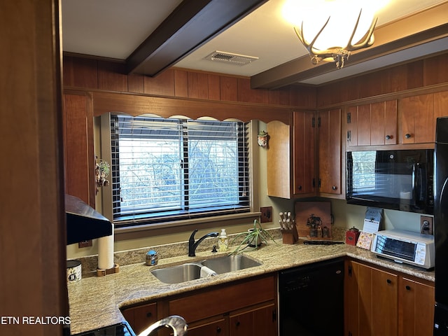 kitchen featuring wood walls, sink, beamed ceiling, and black appliances