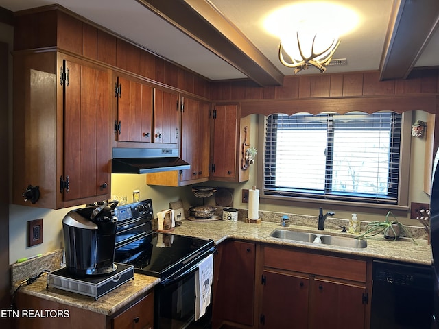 kitchen featuring black appliances, beamed ceiling, an inviting chandelier, sink, and wooden walls