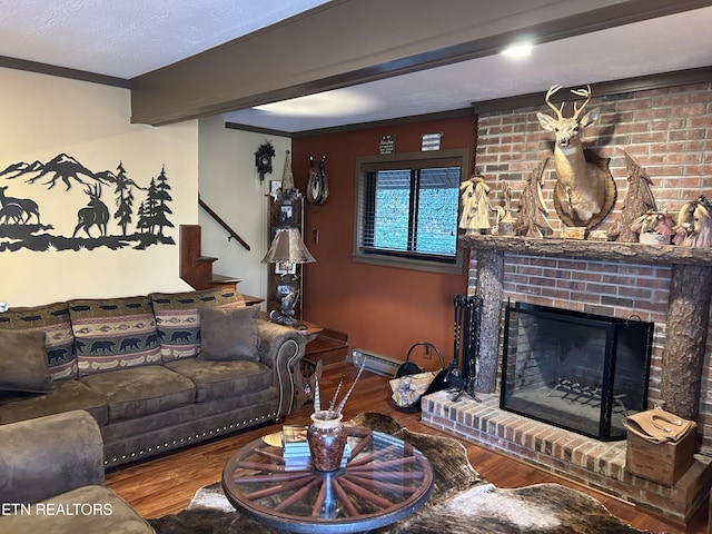 living room featuring a brick fireplace, brick wall, dark hardwood / wood-style floors, and a textured ceiling