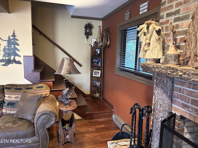 living room featuring crown molding, dark hardwood / wood-style floors, brick wall, and a fireplace